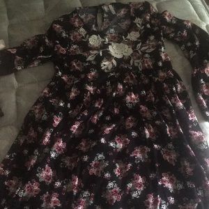 Black flowery dress with long sleeves.